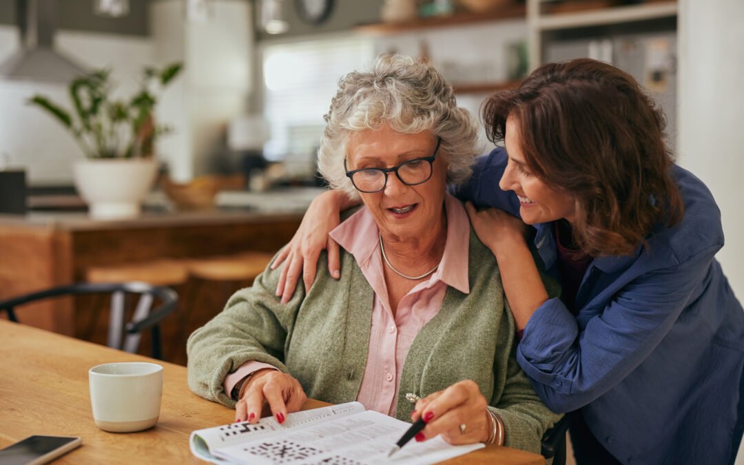 Senior woman solving crossword puzzle with the help of her daughter